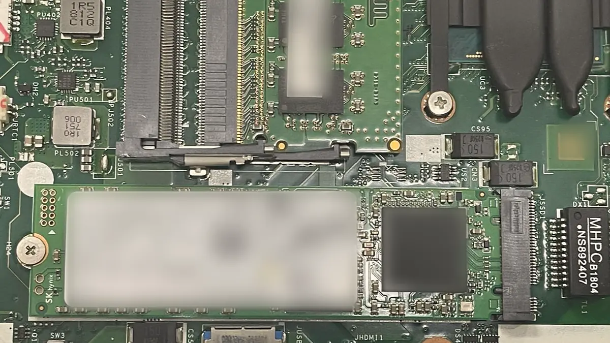 A solid-state drive seated on a laptop mainboard